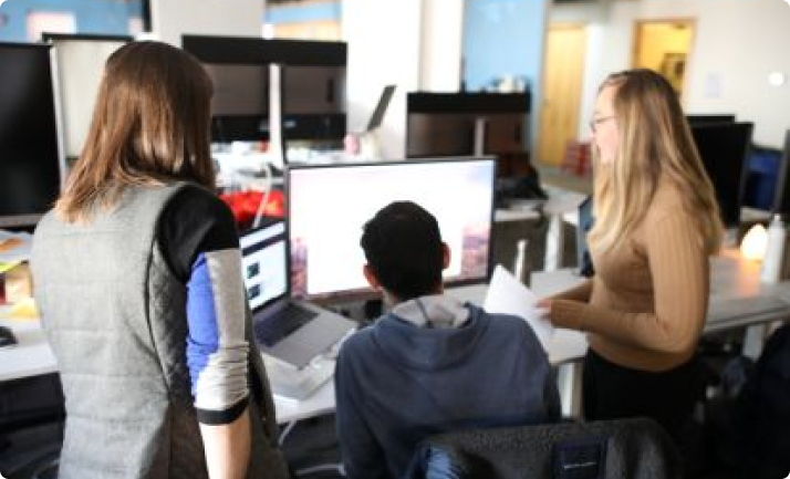 Picture of people looking at a computer