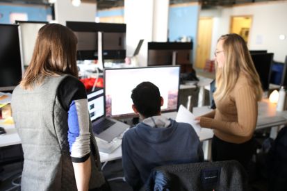 Picture of people looking at a computer