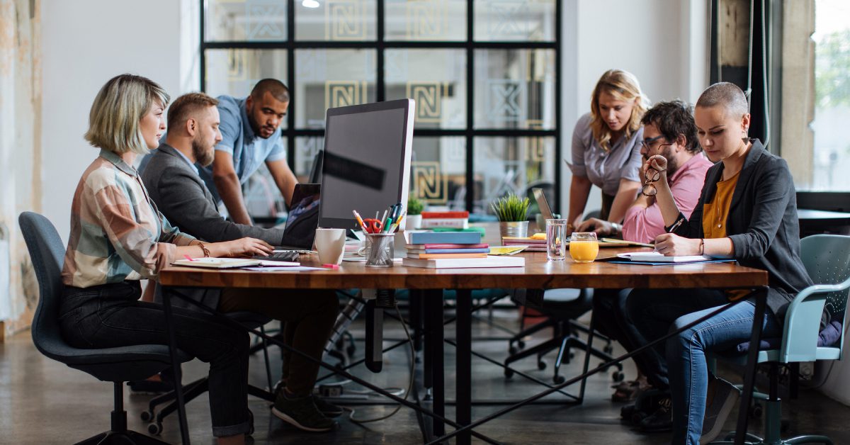 people gathered around a table working together