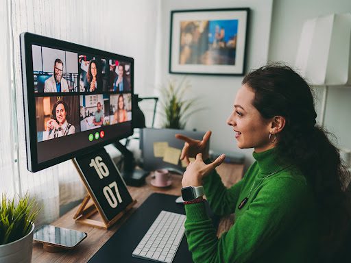 Woman video conferencing with co-workers